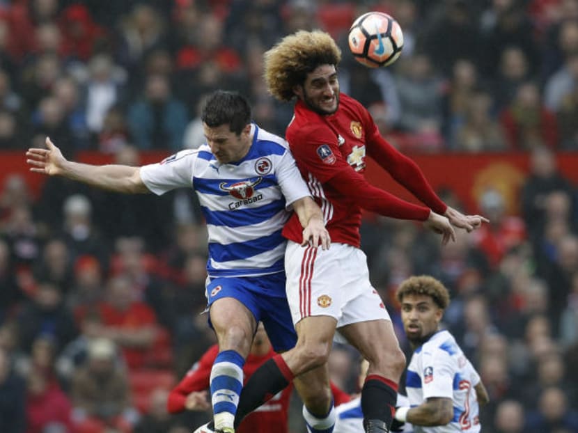 Manchester United's Marouane Fellaini in an aerial duel with Reading's Yann Kermorgant earlier this month. Photo: Reuters