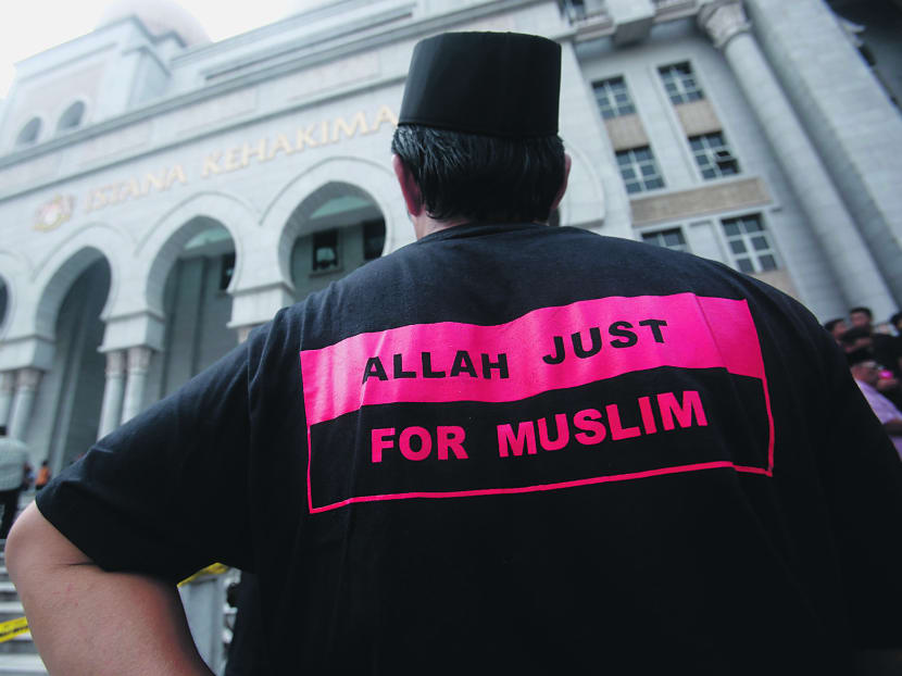 A Muslim man wearing a shirt with the words ‘Allah Just For Muslim’ standing outside Malaysia’s federal court in Putrajaya. The The Kuala Lumpur High Court on Monday rejected a Sabah church’s bid to find out why the Malaysian government banned the word “Allah” in non-Muslims’ publications, saying such government information is classified under the Official Secrets Act (OSA). Photo: Reuters