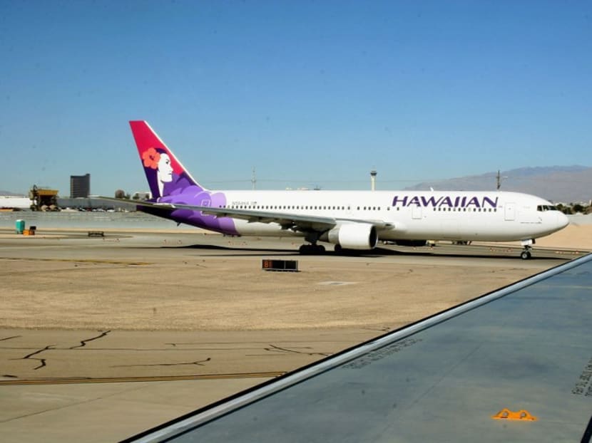 A Hawaiian Airlines jet taxies out to the runway at Phoenix Sky Harbor International Airport. AFP file photo