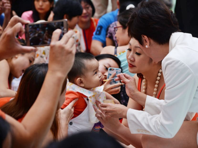 Mrs Josephine Teo (in white) at a Jubilee baby event held at Marina Square yesterday. Photo: Robin Choo