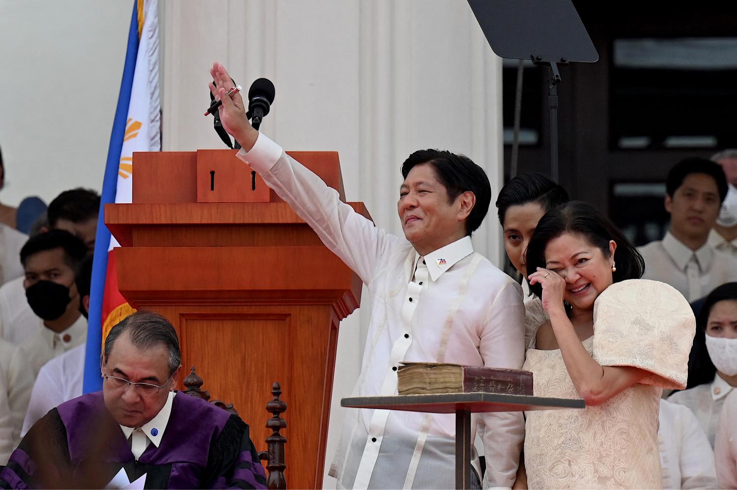 Philippine President Ferdinand Marcos Jr waves to supporters as his wife Louise (right) reacts after he was sworn in as the country's new leader at the National Museum in Manila, on June 30, 2022. Philippine President Ferdinand Marcos Jr waves to supporters as his wife Louise (right) reacts after he was sworn in as the country's new leader at the National Museum in Manila, on June 30, 2022.