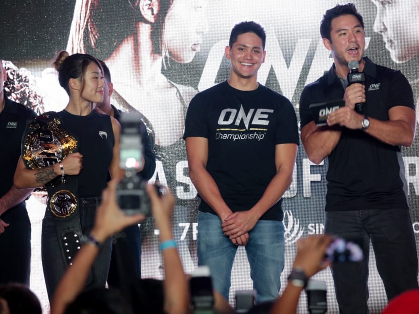 Joseph Schooling (centre) supporting Angela Lee (left) at a One Championship event on Thursday. Photo: Jason Quah