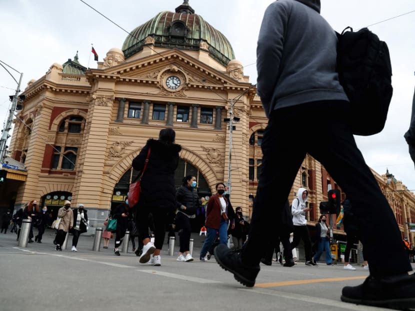 People walk outside Flinders Street Station in downtown Melbourne on Aug 5, 2021, as authorities there announced a sixth lockdown for the city in efforts to bring the Delta outbreak to heel.