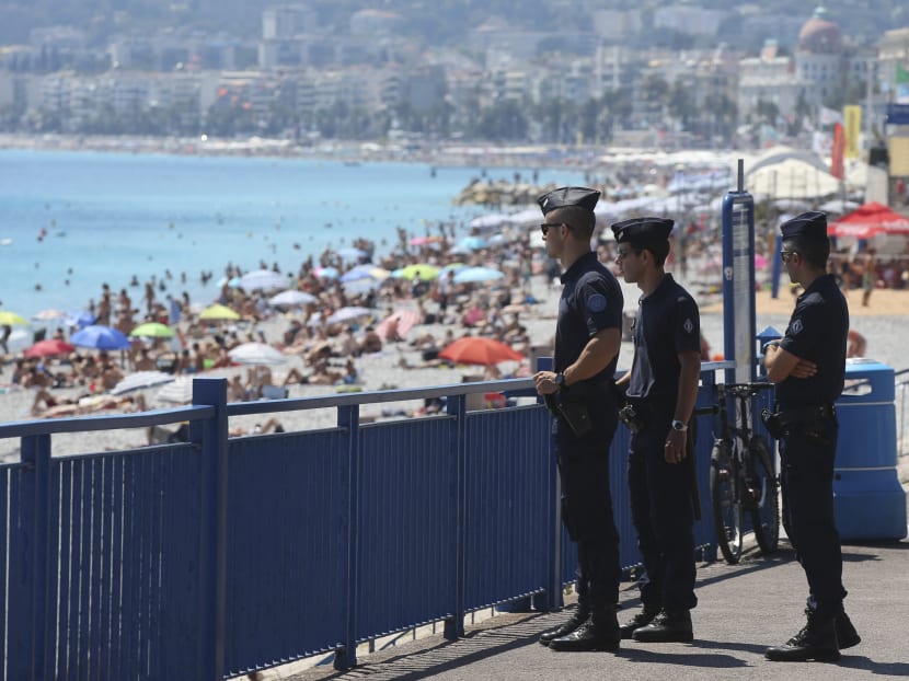 French police officers patrol the famed Promenade des Anglais in Nice, France, three days after a truck mowed through revelers on Sunday, July 17, 2016. Photo: AP