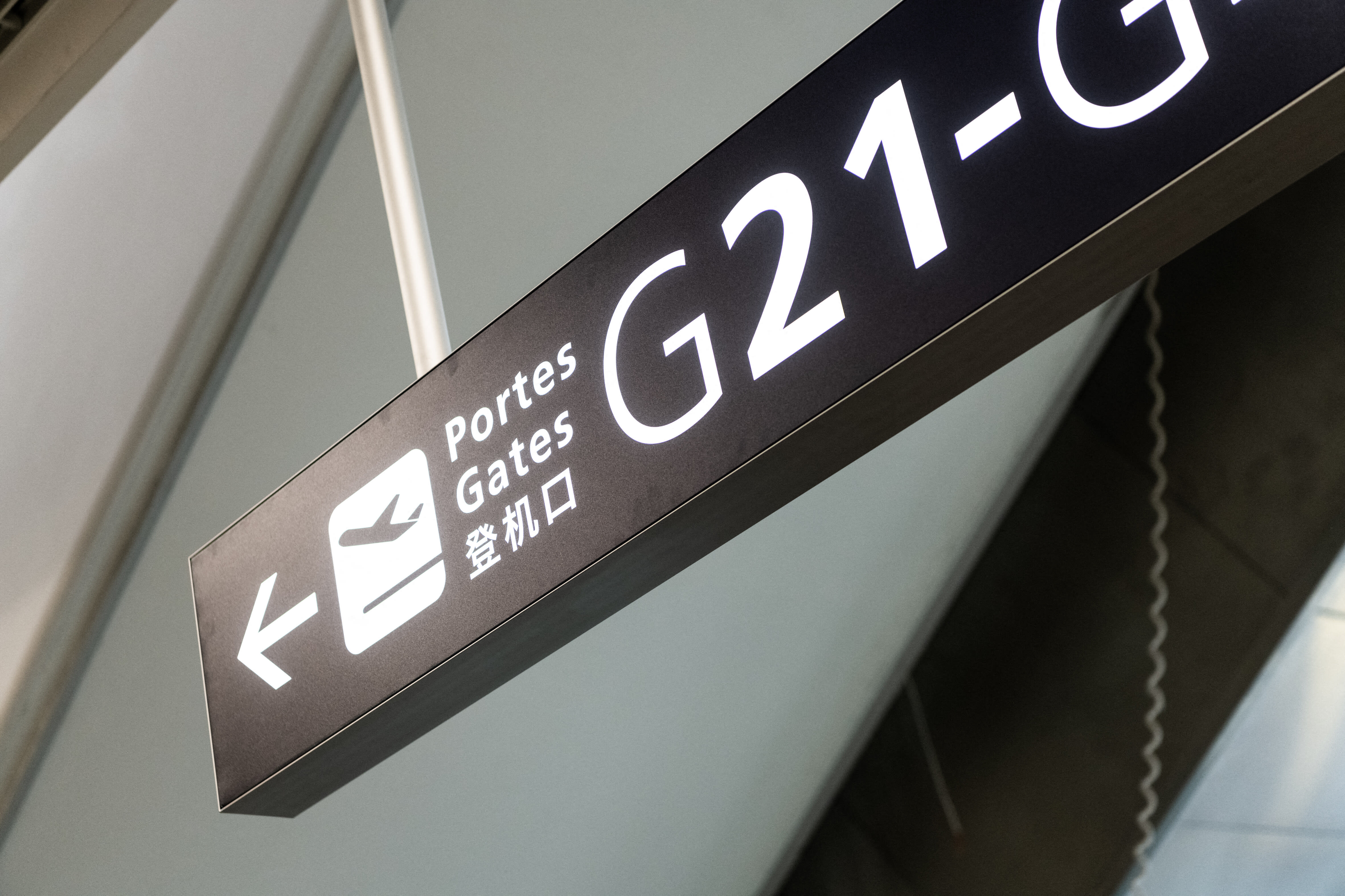 This photograph shows a sign indicating the boarding gates during the opening to the press of the new terminal 2G of Paris Roissy Charles de Gaulle airport, on the outskirts of Paris, France, on April 13, 2022. This photograph shows a sign indicating the boarding gates during the opening to the press of the new terminal 2G of Paris Roissy Charles de Gaulle airport, on the outskirts of Paris, France, on April 13, 2022.