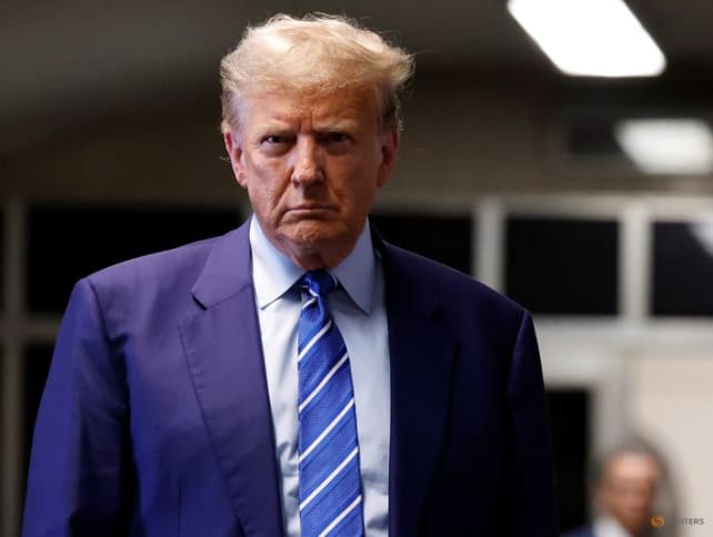 Former President Donald Trump listens to a question as he prepares to leave at the end second day of his criminal trial at NYS Supreme Court on April 16, 2024 in New York City.  