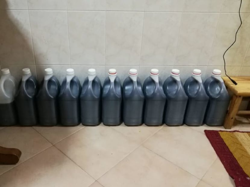 Stocks of the illegal cough syrup in large containers seized from a HDB flat. Stocks of the illegal cough syrup in large containers seized from a HDB flat.