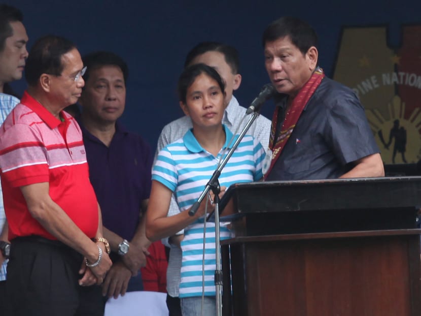 President-elect Rodrigo Duterte (second from right) talks to kidnap victim Marites Flor (centre), who was abducted with two executed Canadians, John Ridsdel and Robert Hall, by Abu Sayyaf militant group, after Flor was released. Photo: REUTERS