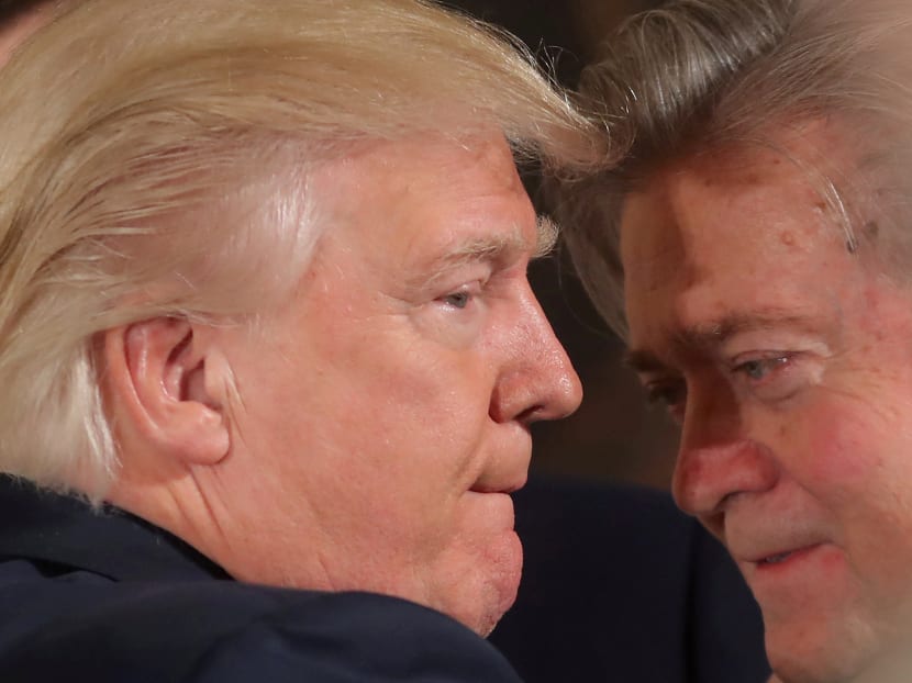 US President Donald Trump talks to former chief strategist Steve Bannon during a swearing in ceremony for senior staff at the White House in Washington. Photo: Reuters