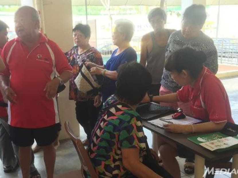 Residents at Hong Kah North constituency participating in the MediShield household check exercise. Photo: Sara Grosse/Channel NewsAsia