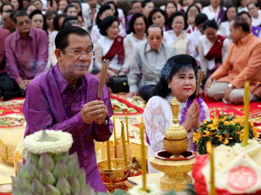 Cambodia’s Prime Minister Hun Sen (L) and his wife Bun Rany taking part in a massive prayer ceremony at Angkor Wat temple. Secured by family and party ties, Chinese cash and his own ruthless political instincts, Cambodian strongman Hun Sen has taken a wrecking ball to the kingdom’s fragile democracy in a campaign to extend his 32-year rule. Photo: AFP