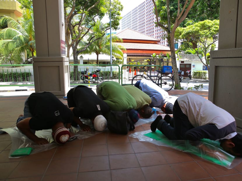 A group of Muslims praying on a walkway opposite Masjid Omar Kampong Melaka on 13 March, 2020.