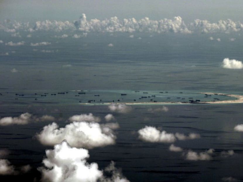 An aerial file photo taken though a glass window of a Philippine military plane shows the alleged on-going land reclamation by China on Mischief Reef in the Spratly Islands in the South China Sea, west of Palawan, Philippines May 11, 2015. Photo: Reuters
