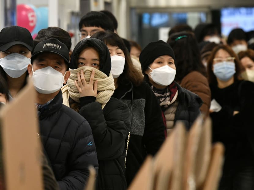 People wait in a line to buy face masks at a retail store in the southeastern city of Daegu, South Korea on Feb 25, 2020.