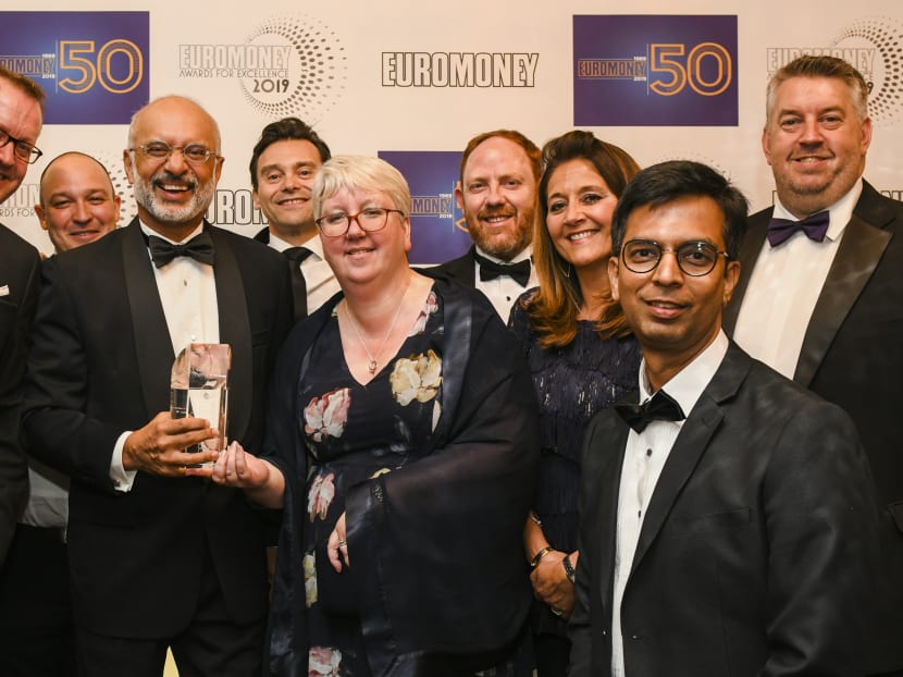 DBS' chief executive officer Piyush Gupta (second row, second from left) at the Euromoney awards ceremony in London with staff members from the bank.
