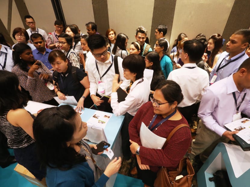 Job seekers waiting to speak with representatives at a job fair. TODAY file photo