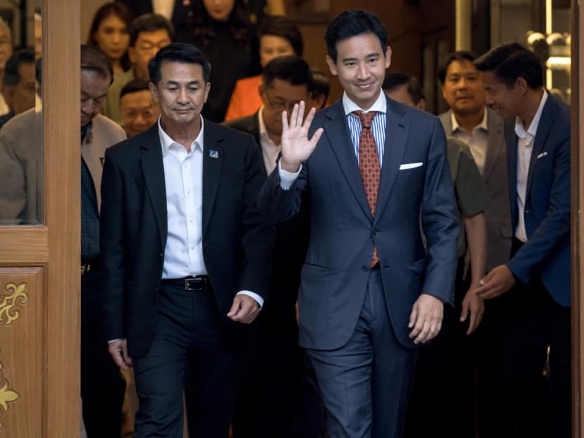 Move Forward Party leader and prime ministerial candidate Pita Limjaroenrat (waving) and Pheu Thai Party leader Chonlanan Srikaew walk next to each other as they gather with potential coalition partners at the entrance of a restaurant in Bangkok on May 17, 2023. Move Forward Party leader and prime ministerial candidate Pita Limjaroenrat (waving) and Pheu Thai Party leader Chonlanan Srikaew walk next to each other as they gather with potential coalition partners at the entrance of a restaurant in Bangkok on May 17, 2023.