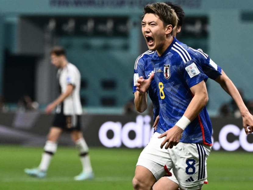 Japan's midfielder #08 Ritsu Doan celebrates scoring his team's first goal during the Qatar 2022 World Cup Group E football match between Germany and Japan at the Khalifa International Stadium in Doha on Nov 23, 2022.
