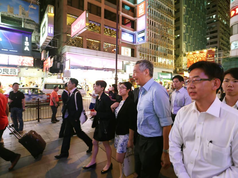 Mr Lee taking a walk down Tsim Sha Tsui in Hong Kong on Wednesday night. Mr Lee pointed out that the One Country, Two Systems principle is unprecedented and the only such arrangement in the world, but the two parties — China and Hong Kong — have to make it work. PHOTO: MCI