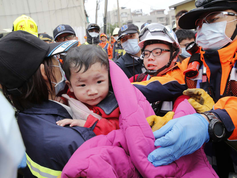 Rescuers bring a boy to safety following an earthquake in Taiwan. Photo: AP