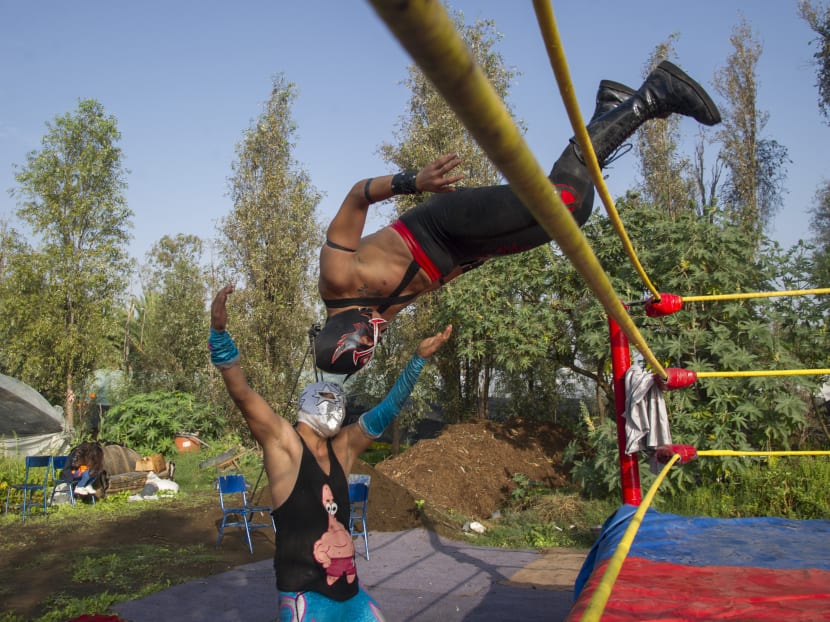 Wrestlers perform during the Chinampalucha event organized by Mexican wrestlers in the chinampas of Xochimilco in Mexico City, on Aug 1, 2020, as rings remain closed due to the Covid-19 pandemic.
