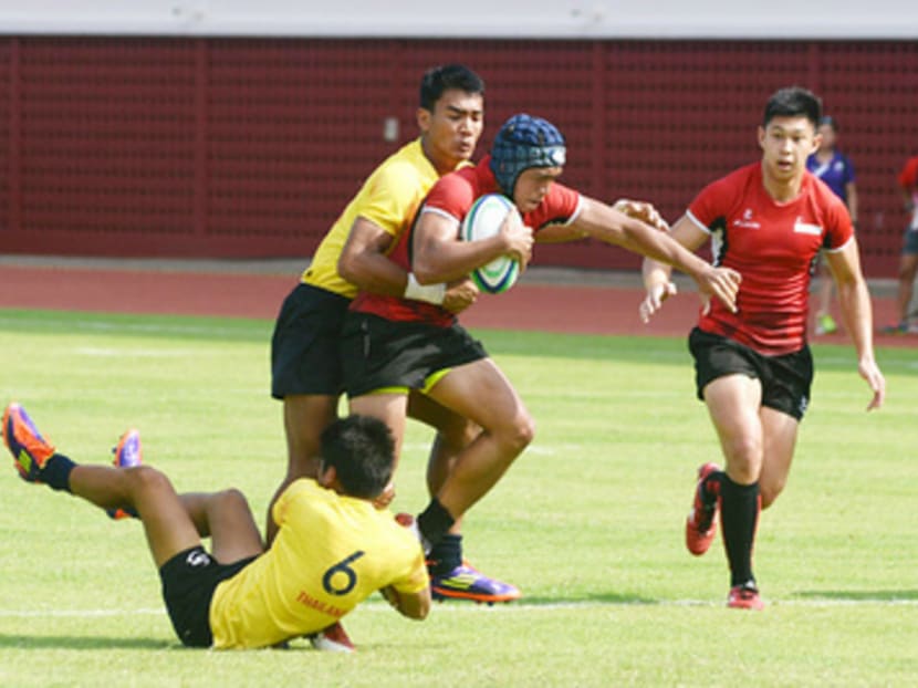 The Singapore men’s rugby sevens team (in red) beat Thailand at the SEA Games 2015 to win the bronze medal, repeating the feat achieved by the women’s team. Photo: Robin Choo