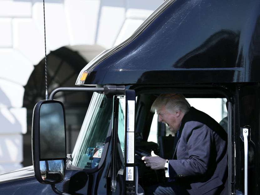 U.S. President Donald Trump reacts as he sits on a truck while he welcomes  truckers and CEOs to attend a meeting regarding healthcare at the White House in Washington, U.S., March 23, 2017.  Photo: Reuters