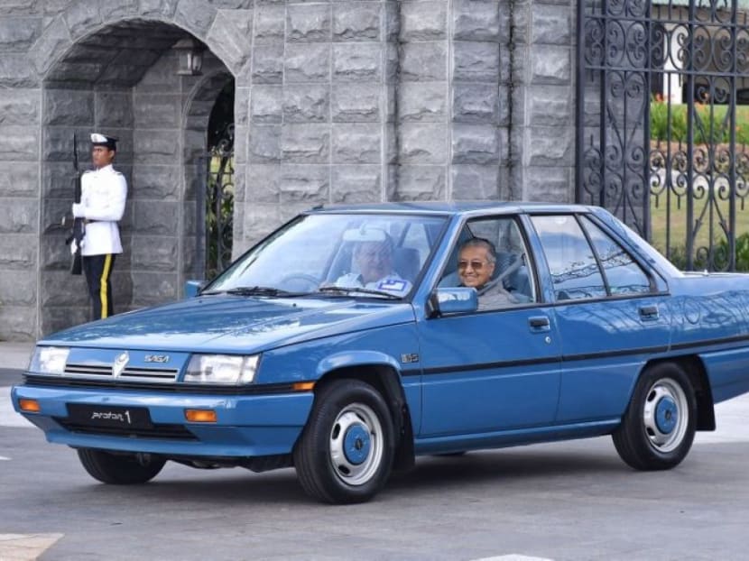 Sultan Ibrahim Sultan Iskandar of Johor and Prime Minister Dr Mahathir Mohamad in a blue Proton Saga.