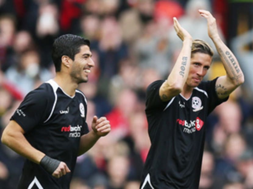 Former Liverpool strikers Luis Suarez (left) and Fernando Torres were accorded the classiest of returns to Anfield for the charity all-star game on Sunday. Photo: Reuters