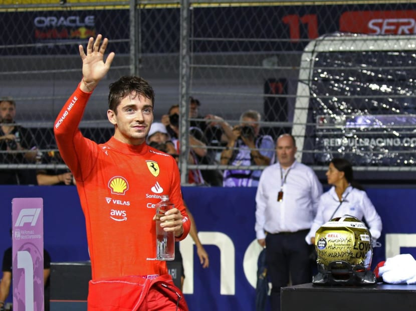 Ferrari's Charles Leclerc waving to spectators after clinching pole position in the Singapore Grand Prix on Oct 1, 2022.