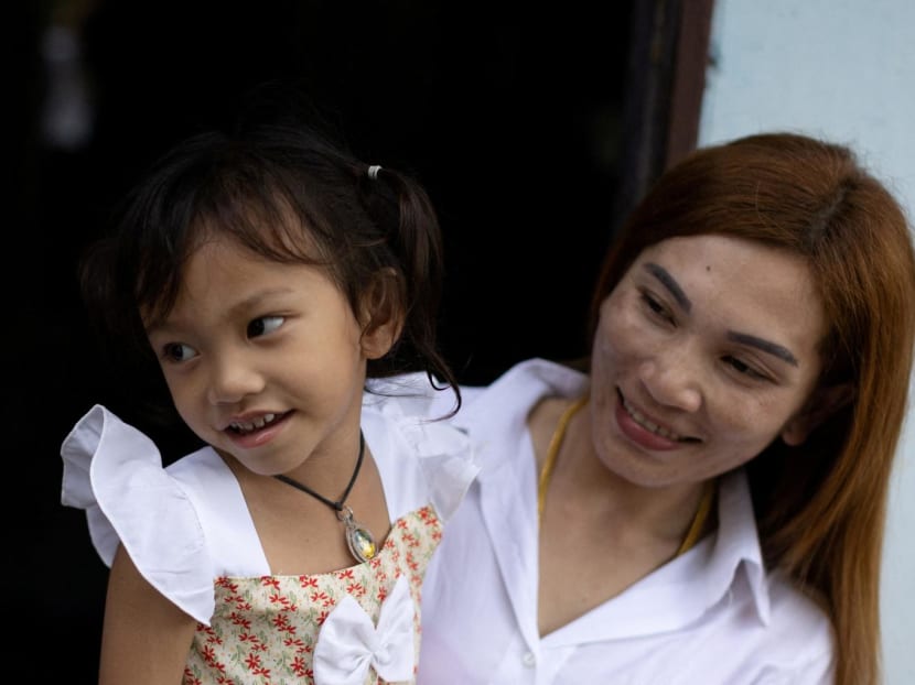 Ms Panompai Sithong holds her 3-year-old daugther Paveenut Supolwong, nicknamed Ammy, who is the only child survivor of the day care centre mass shooting, during a family meeting at their home in Uthai Sawan, Thailand, on Oct 9, 2022. Ms Panompai Sithong holds her 3-year-old daugther Paveenut Supolwong, nicknamed Ammy, who is the only child survivor of the day care centre mass shooting, during a family meeting at their home in Uthai Sawan, Thailand, on Oct 9, 2022.