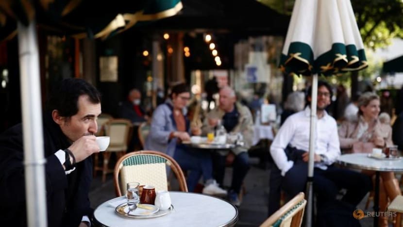 Parisians tuck into coffee and croissants again as cafes re-open Parisians tuck into coffee and croissants again as cafes re-open