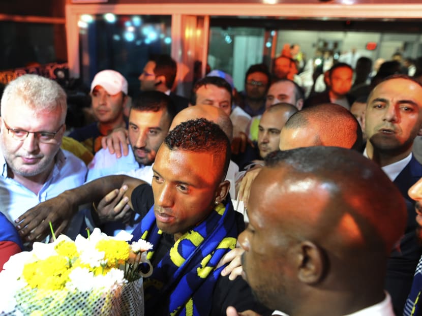 Luis Nani, centre, of Portugal, is ushered through Fenerbahce supporters that gathered to welcome him at the airport in Istanbul, late Sunday, July 5, 2015. Photo: AP