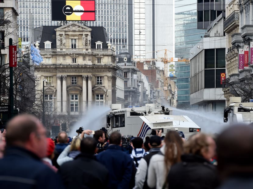 Police fire water cannon at far-right hooligans at Brussels shrine