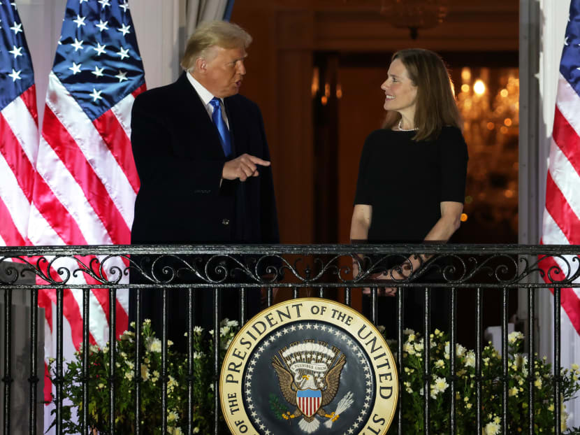 US President Donald Trump and newly sworn-in US Supreme Court Associate Justice Amy Coney Barrett speak during a ceremonial swearing-in on the South Lawn of the White House Oct 26 in Washington, DC.