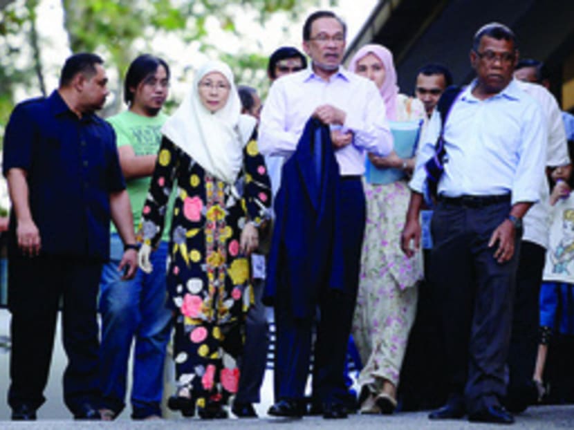 Anwar Ibrahim (centre) arriving at the Federal Court with his family and supporters yesterday. His conviction almost certainly eliminates any hope he has of becoming prime minister. Photo: The Malaysian Insider