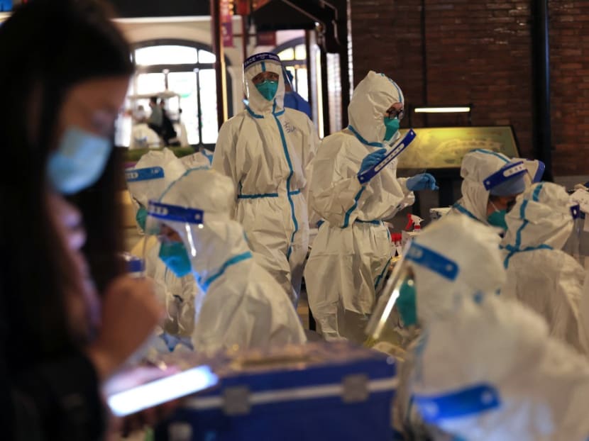 This photo taken on Oct 31, 2021 shows medical personnel preparing to test visitors for the Covid-19 coronavirus at Disneyland in Shanghai after a single coronavirus case was detected at the park on the weekend.