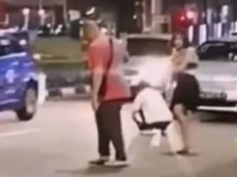 A video circulating online shows a woman stripping in the middle of the road.