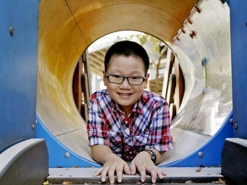 Huo Xi Cheng is one of about 100 children in Singapore diagnosed with cancer each year. His brush with the disease has made him and his parents more cautious about their health. Photo: Wee Teck Hian