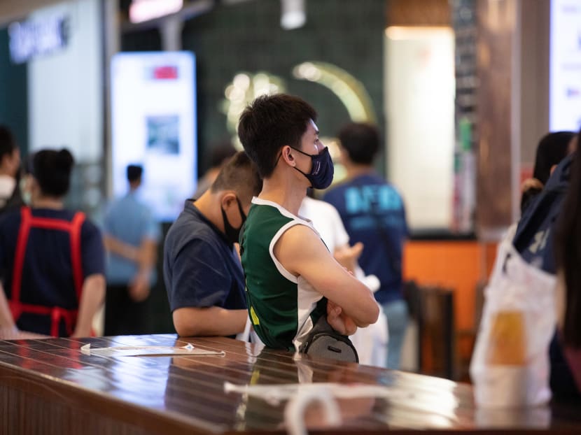 A man wearing a face mask issued by Temasek Foundation at Jem shopping mall on May 18, 2021.