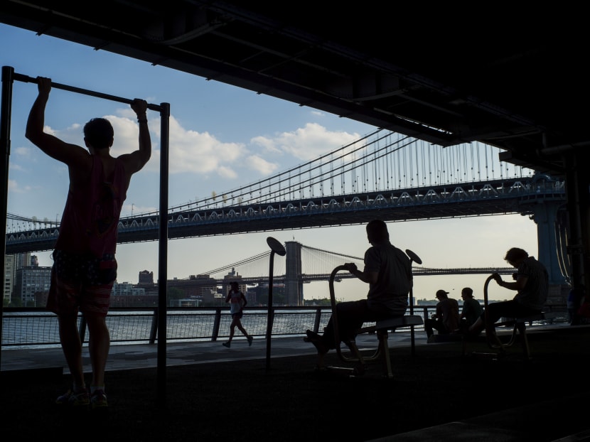 People exercising at a public park along the East River on Manhattan's Lower East Side on June 10, 2015. Photo: New York Times