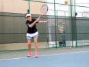 The author playing soundball, or tennis for the blind, using a sound-adapted sponge ball.