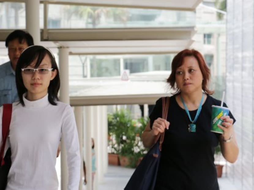 Ms Han Hui Hui (L) arriving at the State Courts. Photo: Channel NewsAsia