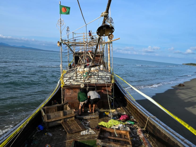 People inspect a boat that was used by the Rohingya refugees at Lamnga beach in Aceh province on Jan 12, 2023. Thousands of the mostly Muslim Rohingya, heavily persecuted in Myanmar, risk their lives each year on long and expensive sea journeys — often in poor-quality boats — in an attempt to reach Malaysia or Indonesia.