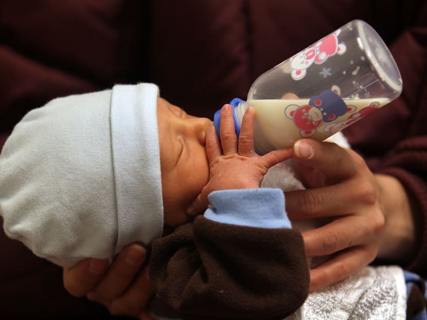 A baby seen drinking breast milk from a bottle during a newborn care class on February 23, 2010, in Aurora, Colorado. Photo: AFP
