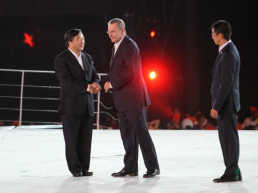 Ji Jianye, former mayor of Nanjing, China, shakes hand with the IOC President Jacques Rogge during the Singapore Youth Olympic Games 2010 closing ceremony on Aug 26, 2010. TODAY file photo