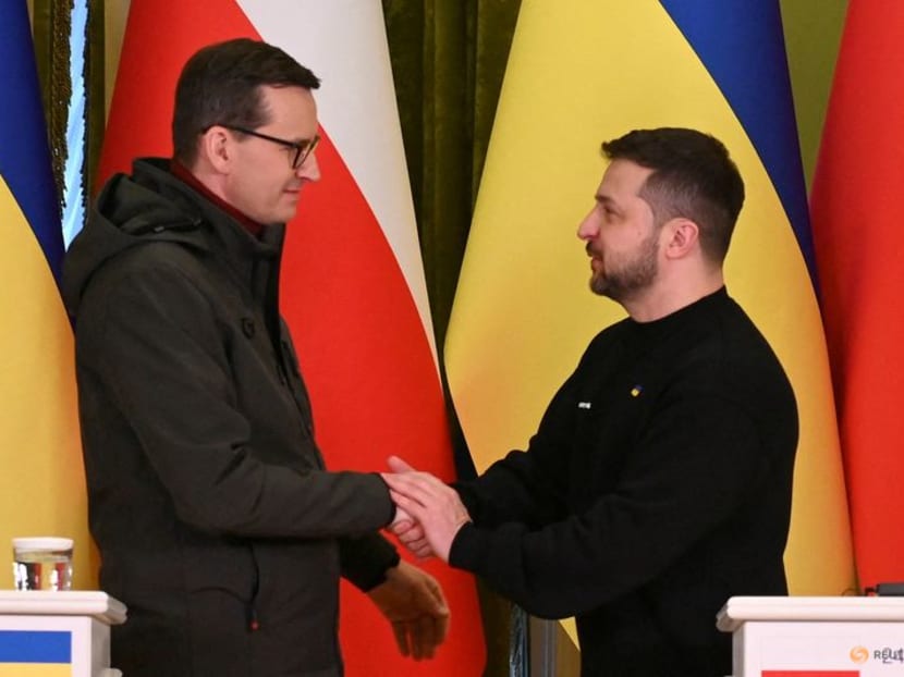 FILE PHOTO: Ukraine's President Volodymyr Zelenskiy and Polish Prime Minister Mateusz Morawiecki shake hands during a joint news briefing on a day of the first anniversary of Russia's attack on Ukraine, in Kyiv, Ukraine February 24, 2023.  REUTERS/Viacheslav Ratynskyi/File Photo