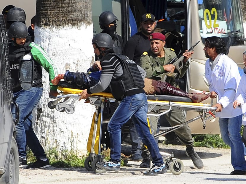 A victim is being evacuated by rescue workers outside the Bardo museum in Tunis, Wednesday, March 18, 2015 in Tunis, Tunisia. Gunmen opened fire at a leading museum in Tunisia's capital, killing 19 people  including 17 tourists, the Tunisian Prime Minister said. A later raid by security forces left two gunmen and one security officer dead but ended the standoff, Tunisian authorities said. Photo: AP