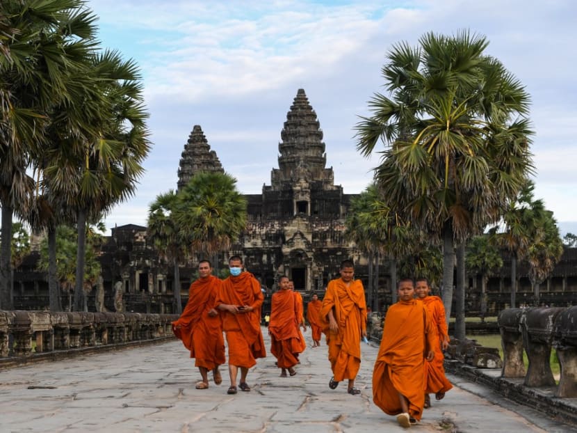 Buddhist monks walk in the compound of the Angkor Wat temple in Siem Reap province on Nov 29, 2020.