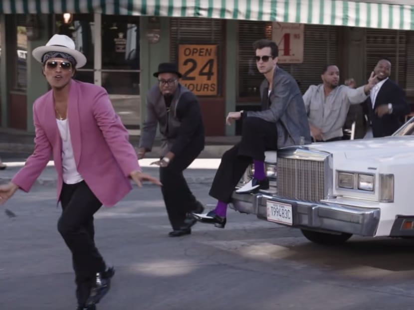 Mark Ronson (in grey jacket and purple socks, seen here with Bruno Mars in a clip from the Uptown Funk video) is part of the line-up for the Beach Beats Fest. Photo: YouTube
